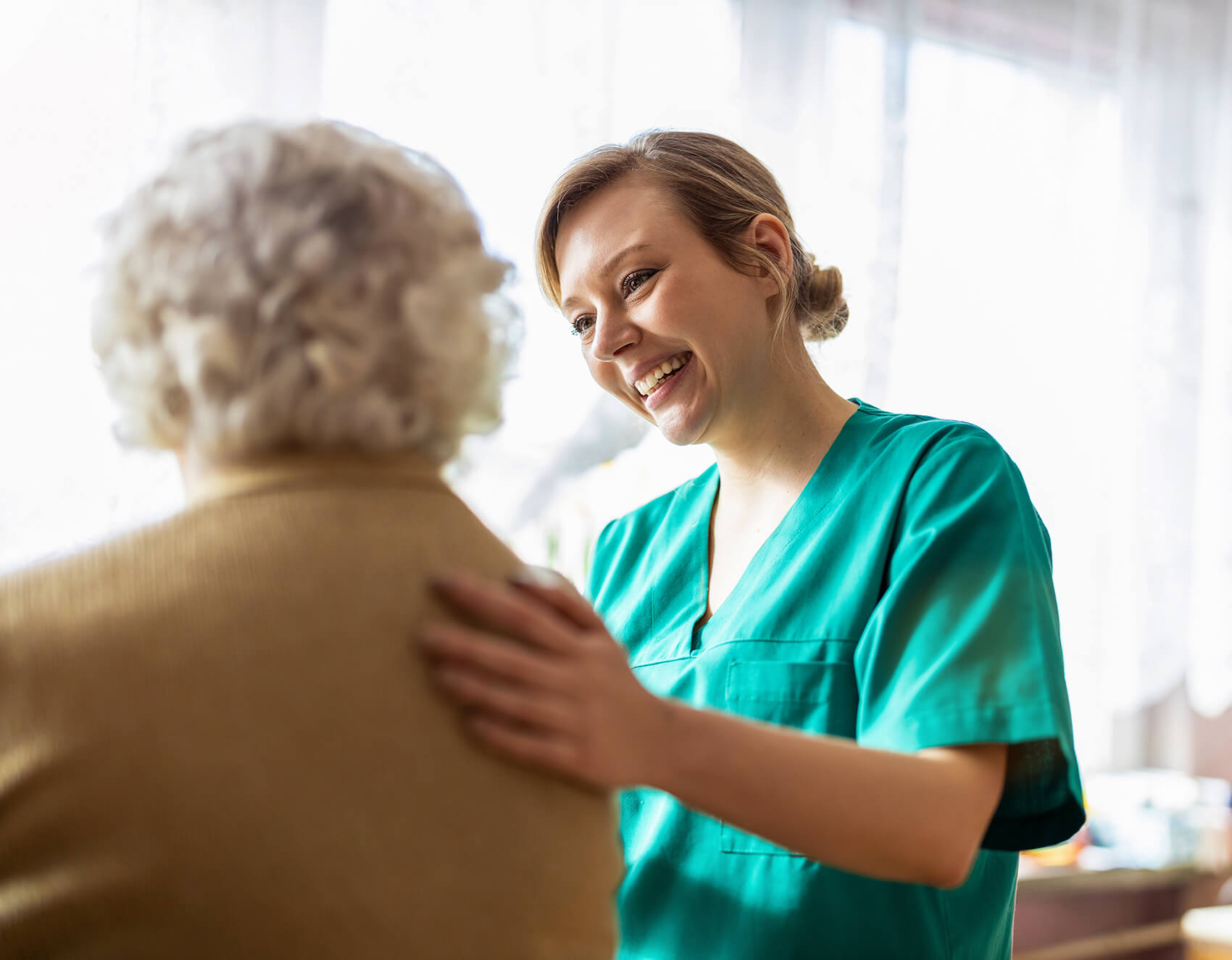 Young carer smiles at elderly patient